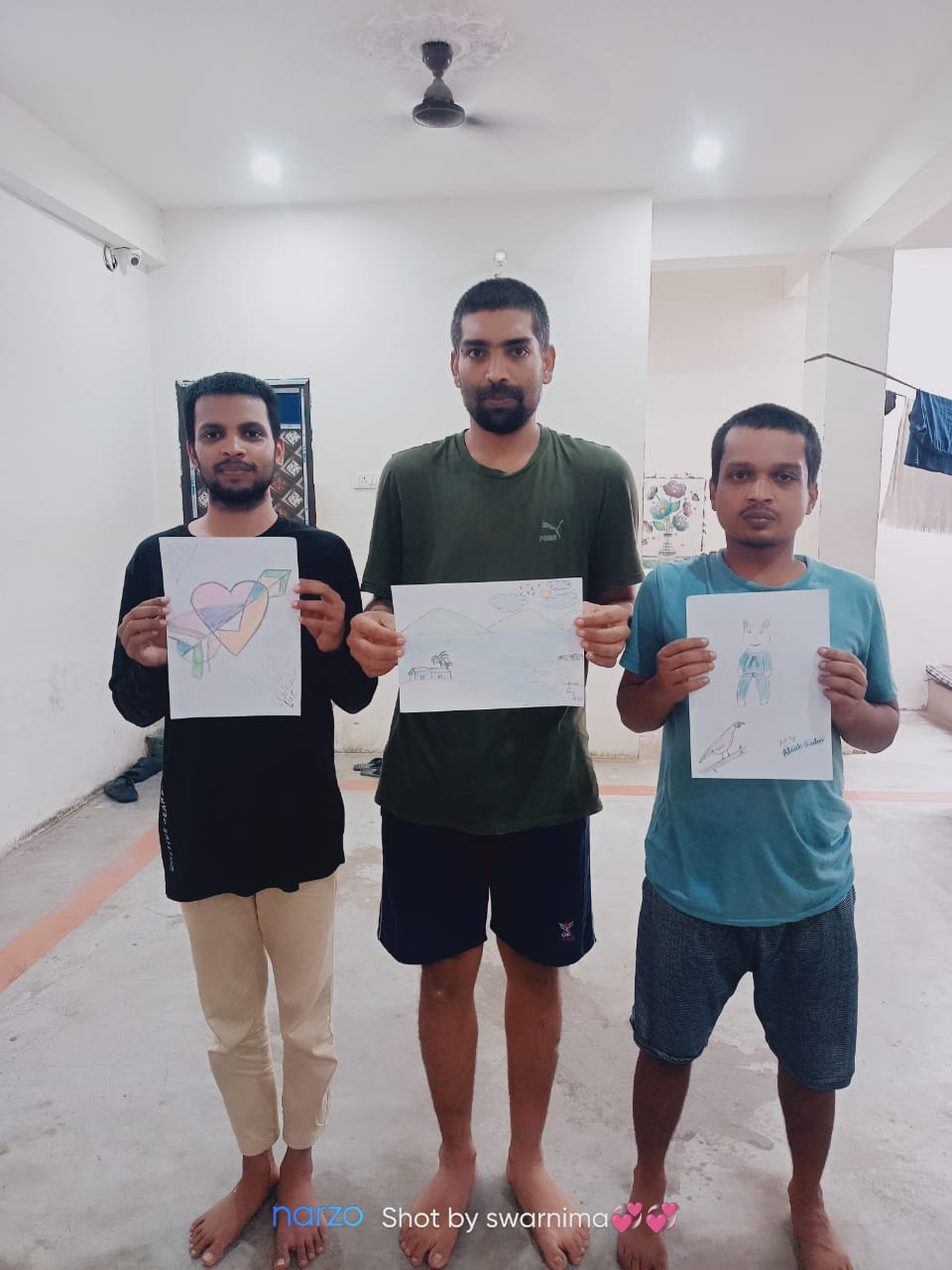 Residents showing artwork made during creative therapy sessions